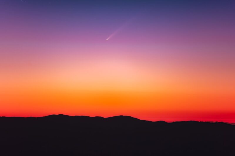 Colorful sunrise sky with comet.