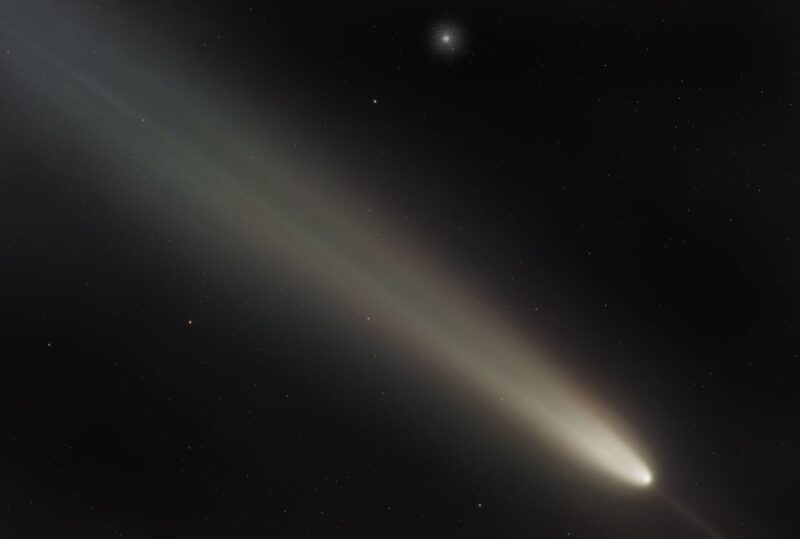 A comet and at the top is a cluster of small dots of light.