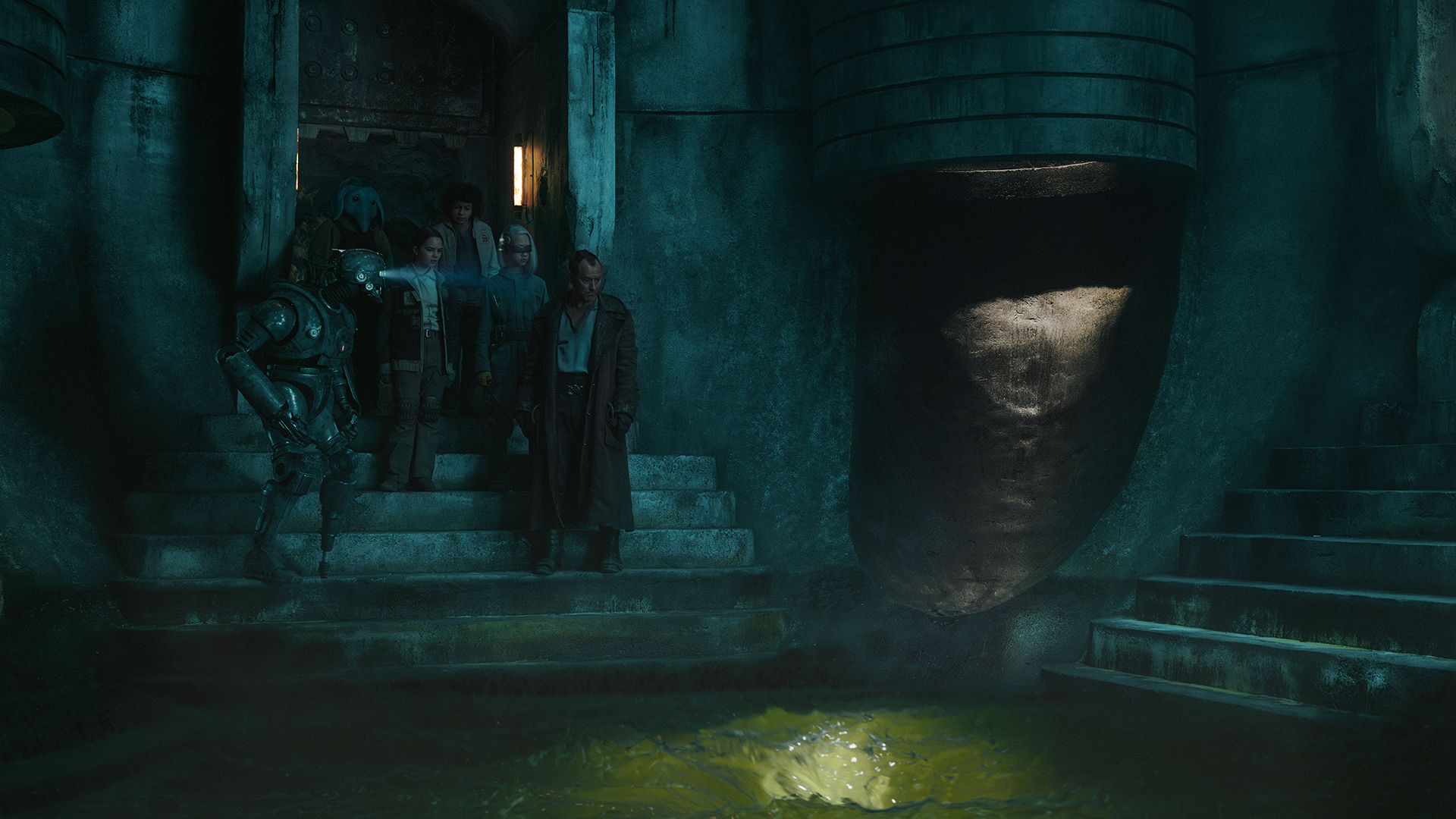 A man and four children entering an ancient-looking room.