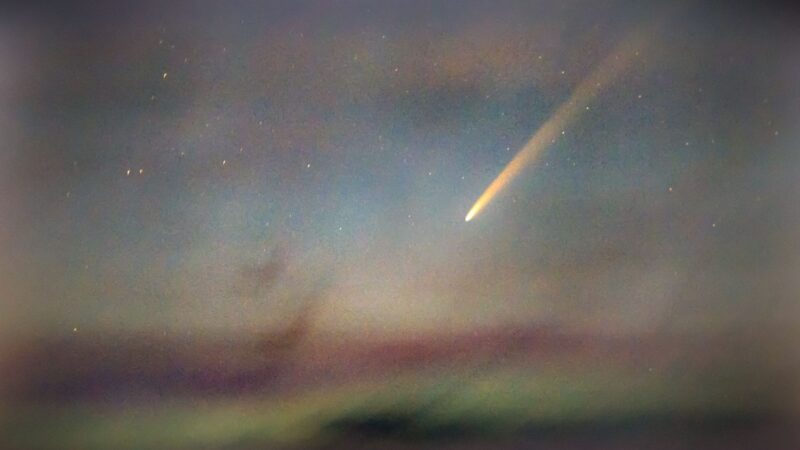 Colorful sky with a white comet with long tail.