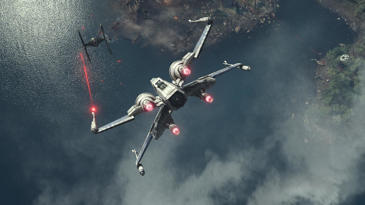 An x-wing spaceship chasing down a TIE fighter over a large body of water, firing red laser shots at it.