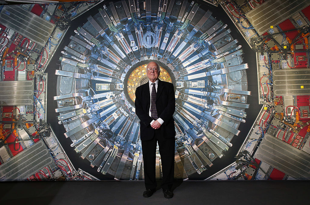 Peter Higgs seenin front of a photograph of the Large Hadron Collider at the Science Museum's 'Collider' exhibition on November 12, 2013 in London, England.