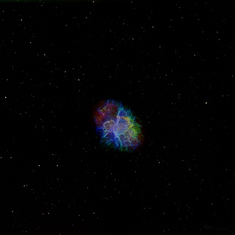 Multicolored egg-shaped cloud, like an explosion frozen in space, with scattered stars.