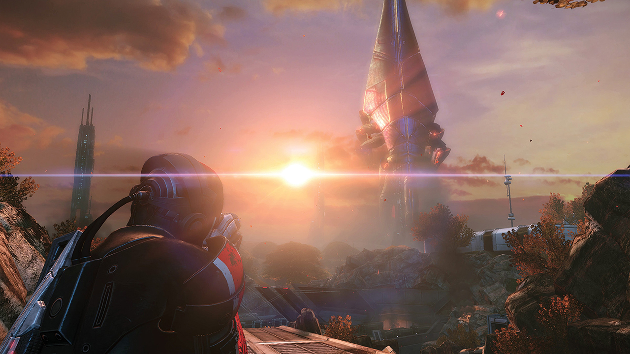 A screenshot from Mass Effect 3 showing Commander Shepard from behind, staring down a massive alien Reaper as it invades from Cosmos.