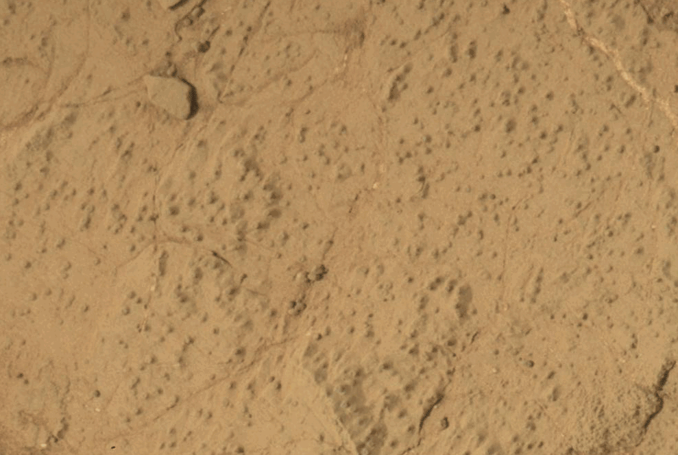 two photos: one showing a pebbly reddish-orange surface; the second showing a dusty hole drilled into the same surface
