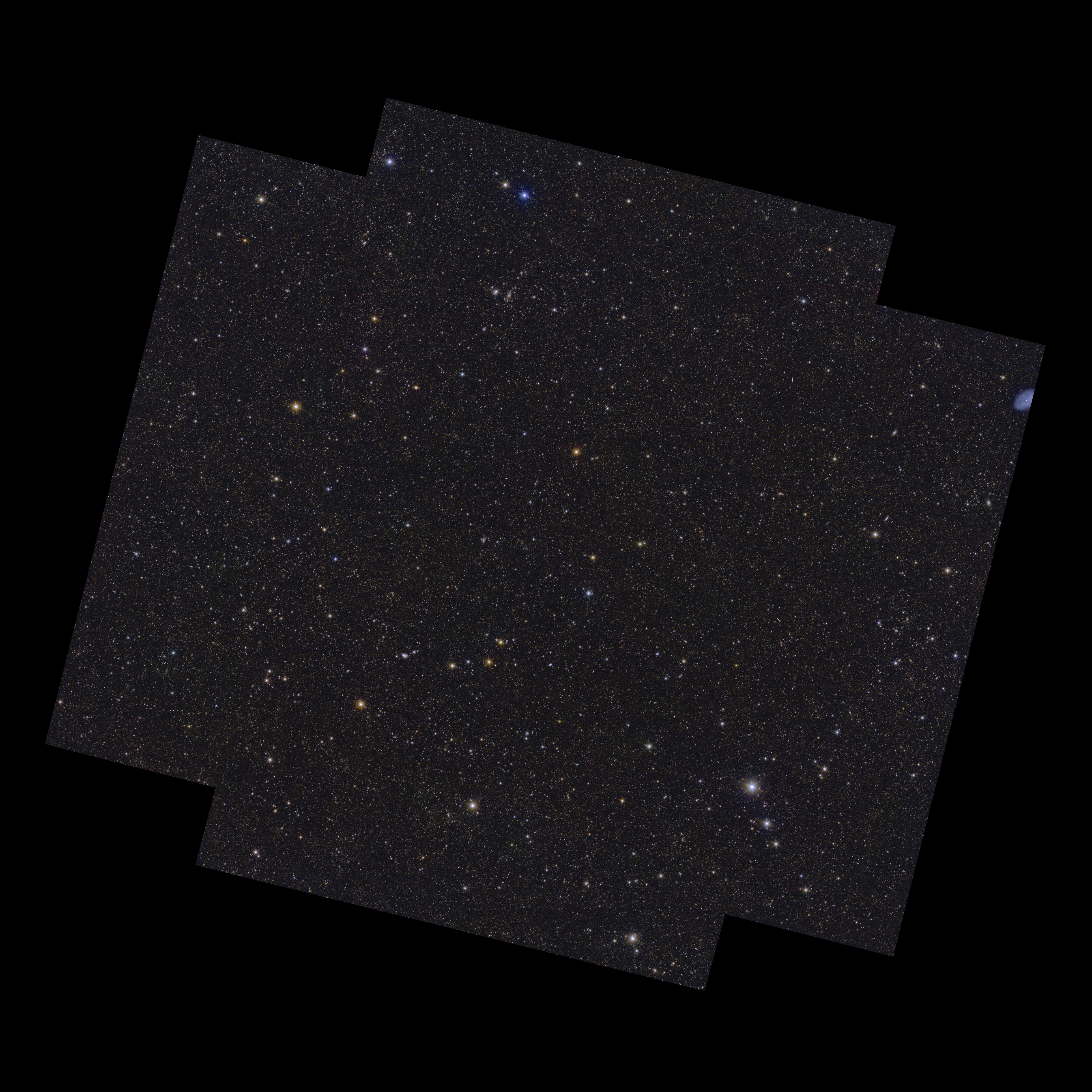 On a black background lies an almost square shape with notches cut out of its corners, oriented with its upper and lower edges sloping slightly from top left to bottom right. Contained within the shape are 4.5 million galaxies, and stars of various size, brightness and colour. Some of the brighter stars have diffraction spikes.]