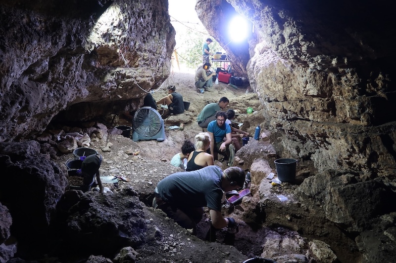 People digging in a cave. Findings from this research Assist a theory that modern humans and Neanderthals in the Levant interacted with All other.