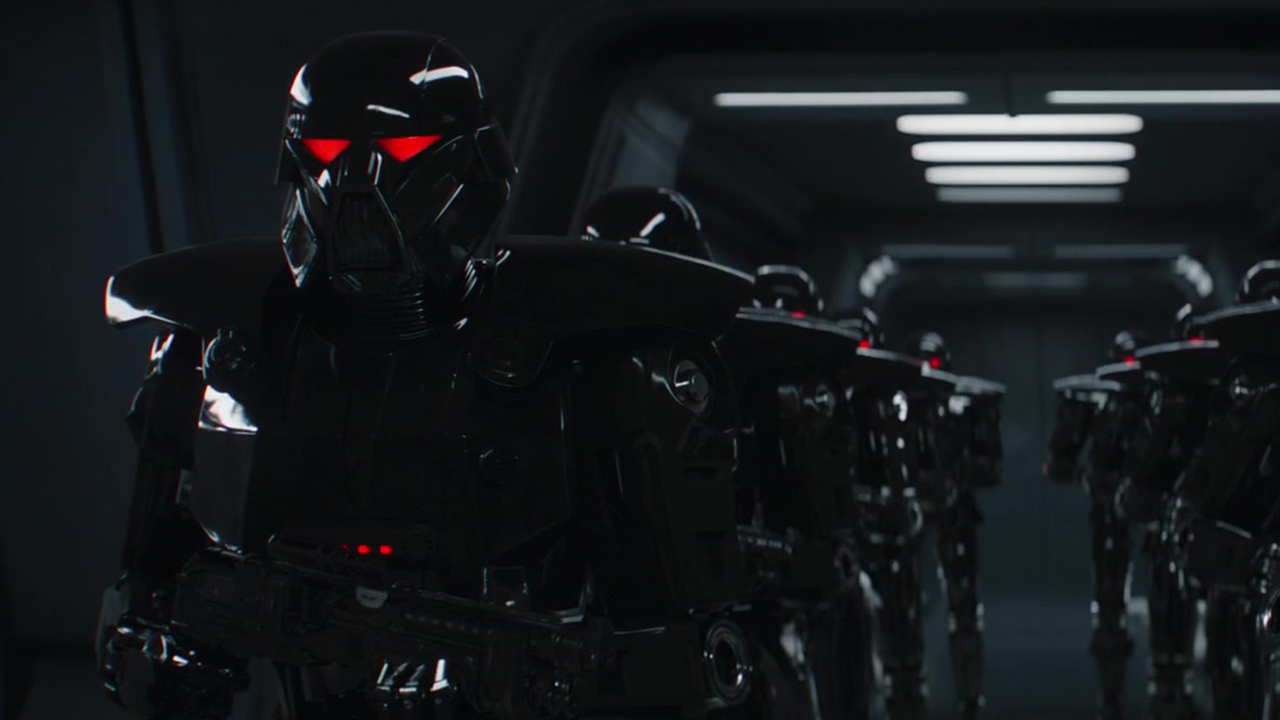 Still from The Mandalorian TV series. There are two rows of menacing super soldiers. They are wearing Weighty black armor, complete with a black helmet with glowing red eyes. They All Stoppage a large gun.