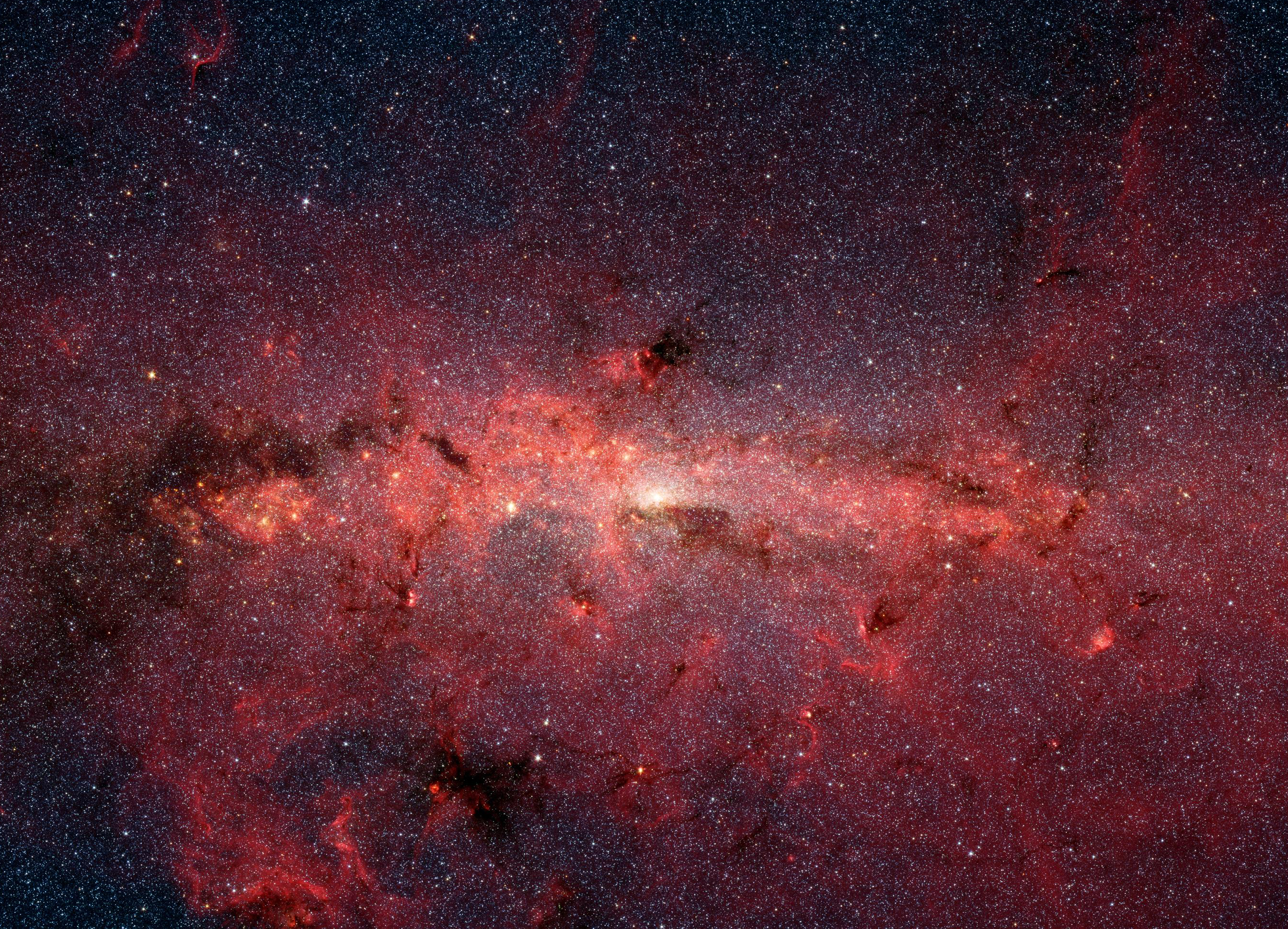 A line of dense red dust and gas against a fainter red background