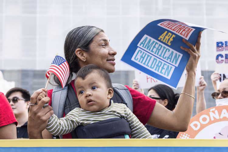 Olga Urbina and nine-month-old Ares Webster join supporters of birthright citizenship outside the Supreme Court, where the high judges are hearing a Trump Administration challenge to the constitutional provision in Washington, May 15, 2025.