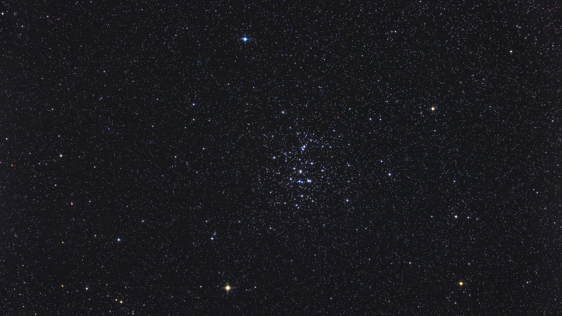 a dense, colorful group of stars in the night sky